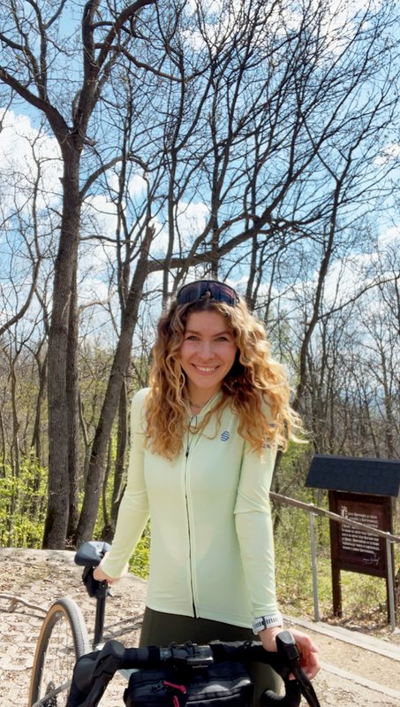 Diana in a light green cycling jersey